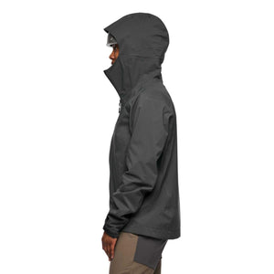 Side view of a person wearing a black Black Diamond hooded shell jacket