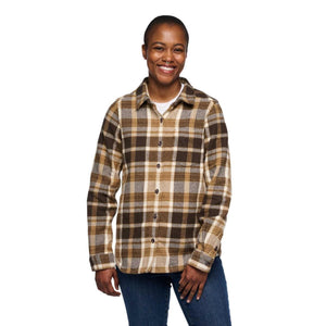 Person wearing a brown and tan plaid button down flannel shirt