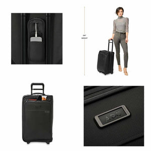 Briggs and Riley black carry on luggage with integrated USB port, scale reference, and monogram patch