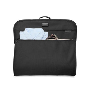 Briggs and Riley black garment bag with a light blue shirt and belt visible in the front pocket