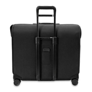 Back view of a black Briggs and Riley rolling garment bag with extended handle