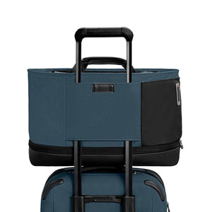 Briggs and Riley blue tote bag attached to luggage handle
