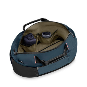 Open interior of a blue Briggs and Riley duffel bag showing pockets and lining