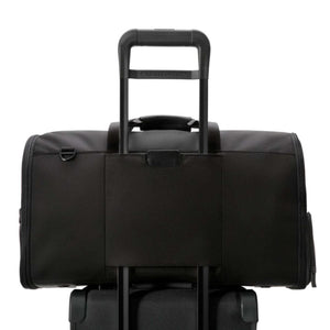 Black Briggs and Riley travel bag attached to a luggage handle