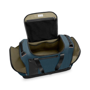 Open blue Briggs and Riley duffel bag with interior pockets and black handles