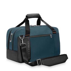 Briggs and Riley blue duffel bag with black handles and shoulder strap