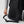 Person adjusting the chest strap on a black Fjallraven backpack
