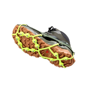 Snowline traction spikes attached to the sole of a hiking shoe