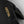 Black Hestra glove with gold embroidered logo and yellow stitching
