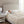 Person sleeping under a Beautyrest heated blanket on a bed with a beige upholstered headboard