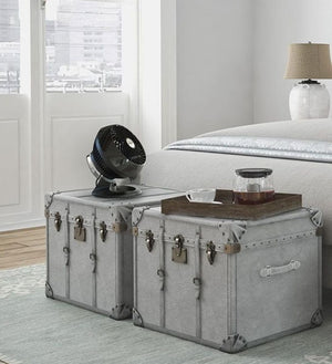 Vornado black air circulator fan on a grey vintage trunk bedside table