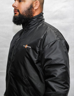 Man wearing a black California Heat jacket with a high collar