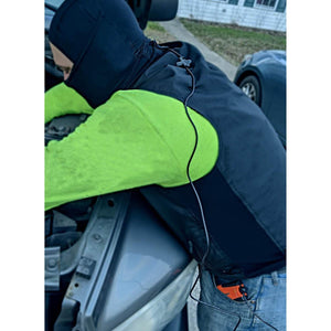 Person wearing a California Heat electric vest and balaclava working on a car engine