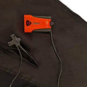 California Heat portable battery pack with power button and charging cable on black fabric