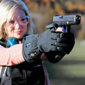Woman wearing protective eyewear and black shooting gloves holding a handgun
