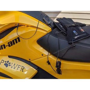 Heated gloves connected to a yellow Can-Am motorcycle battery