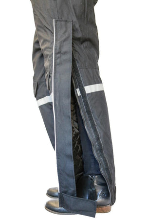 Side view of black waterproof overpants with side zipper and reflective strip
