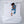Person sleeping on a Cool Care Technologies blue cooling pad on a white bed