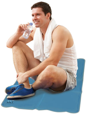 Man sitting on a blue Cool Care Technologies cooling mat drinking water