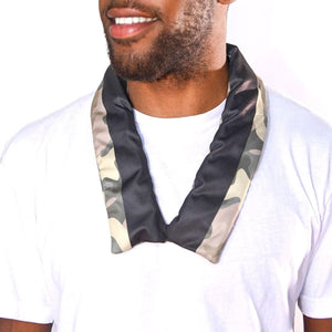 Man wearing a black and camouflage patterned cooling neck wrap over a white t-shirt