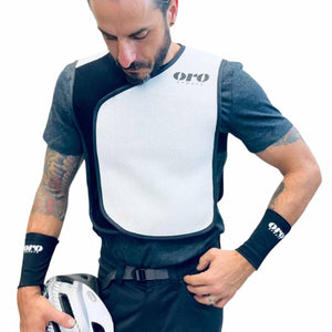 Man wearing Oro Sports white and black protective chest vest and wristbands
