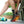 Person wearing a black HealthyLine heated ankle wrap with glowing orange heating elements