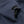 Close up of navy blue jacket sleeve with adjustable velcro strap and elasticated cuff