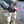 Person wearing Glacier Glove brand gloves while holding a fly fishing rod in a river