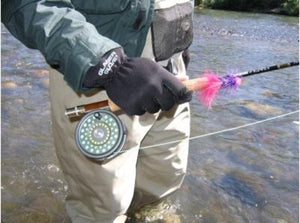 Person wearing Glacier Glove brand gloves while holding a fly fishing rod in a river
