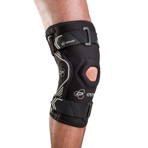 DonJoy Performance black knee brace with straps and open patella worn on a leg