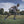 Athlete running on a field wearing a DonJoy knee brace