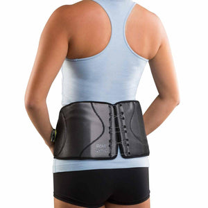 DonJoy back brace worn around the waist over a light blue tank top