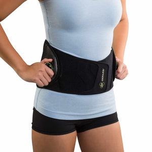Person wearing a black DonJoy back brace with adjustable side dials