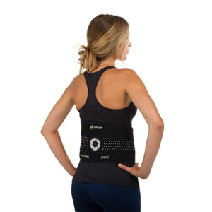 Woman wearing a black DonJoy BoldForm back brace over a black tank top