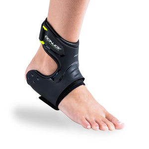 DonJoy Performance black ankle brace worn on a bare foot