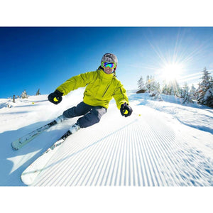 Skier wearing Dr Warm gloves and gear on a sunny snowy slope