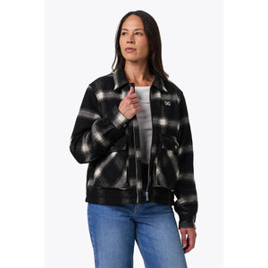 Woman wearing a black and white plaid Mobile Warming zip up jacket with front pockets