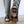 Rubber boot with black and orange traction cleats attached to the sole