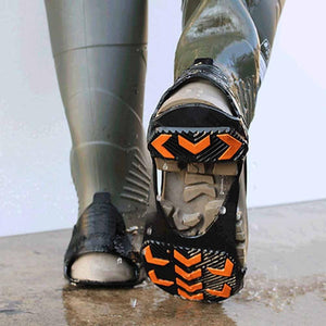 Rubber boot with black and orange traction cleats attached to the sole