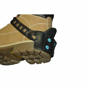 Black rubber ice cleat attached to the heel of a tan work boot