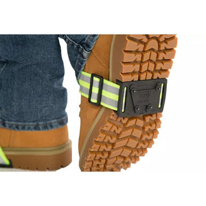 Qwik Grip traction device attached to the sole of a tan work boot