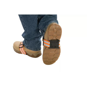 Due North traction aid attached to tan work boots worn with blue jeans