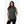 Woman wearing a Mobile Warming olive green quilted vest over a long sleeve shirt