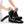 Person adjusting a black HealthyLine heated ankle wrap with velcro straps