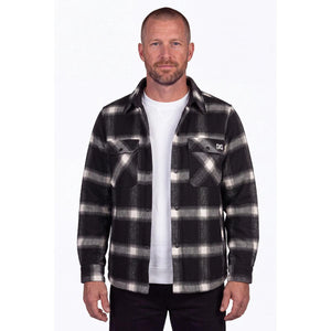 Man wearing a black and white plaid Mobile Warming flannel shirt over a white shirt