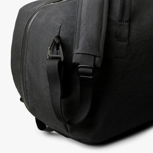 Close up of Bellroy black duffel bag shoulder strap attachment and carabiner