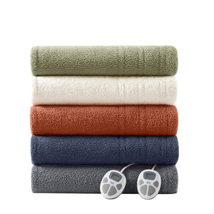 Stack of five folded Serta heated blankets in various colors with two digital controllers
