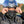 Motorcyclist wearing a California Heat jacket and HJC helmet adjusting a black face mask