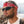 Man with short hair wearing a red paisley bandana and black sunglasses