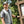 Man wearing a Chill-Its cooling vest standing next to a park trail map